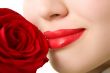 Close-up of beautiful girl with red rose