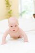 Baby crawling on bed at bedroom