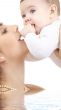 happy mother playing with baby boy in water