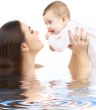 happy mother with baby boy in water #2