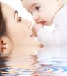 happy mother playing with baby boy in water 2