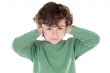 Child holding his hands against his ears