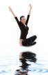 fitness in black leotard on white sand