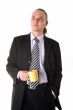 Serious looking businessman holding coffee cup