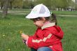 little girl in red coat tear flower dandelion