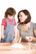 mother and daughter in the kitchen making a dough