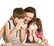 mother and children in the kitchen making a dough