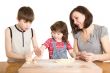 mother and children in the kitchen making a dough