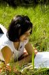 pretty young brunette readind in the park