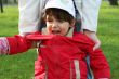 little girl is crying outdoors in spring park