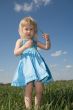 little girl with grass in hands