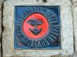 detail of a stone sun figure on wall