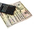 The calculator atop of dollar banknotes