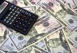 Calculator atop of dollars for backrounds