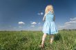 little girl on wide green meadow