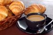 cup of coffee with fresh croissants