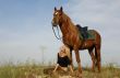 teen and horse in field
