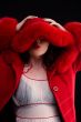 girl in red fur coat blowing kiss