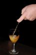 Waiter pouring white wine into glass