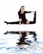 fitness instructor in black leotard on white sand #2
