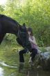 child and horse in river