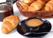 cup of coffee with fresh croissants