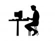 Man typing at a computer
