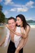 happy playful couple at the beach
