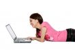 teenager working on her laptop happily