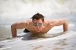 guy getting up from the beach