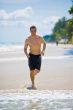 caucasian man running on the beach