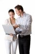 A businesswoman and businessman pay attention