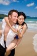 playful couple at the beach looking sideways