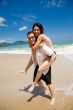 hunk carrying woman piggyback style ath beach