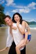 happy playful couple at the beach