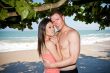 couple hugging by beach