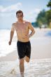 caucasian man running on the beach