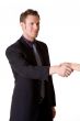caucasian man in business suit making a hand shake