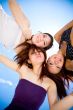 young girls gather around under the bright sunny sky