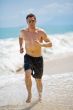 caucasian man running on the beach