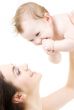 laughing blue-eyed baby playing with mom