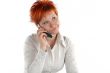 red haired woman talking by mobile phone unhappy