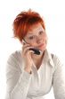 red haired woman talking by mobile phone unhappy