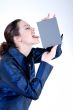 Woman with long curly hair licking a grey card