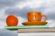 Orange, cup and books
