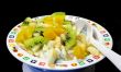 Fruit salad in a plate on a black background