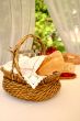 Table setting with bread basket with wine bottles on background