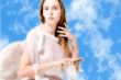Beautiful angel in the clouds doing her hair