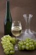 White wine with bottle, glasses and grapes
