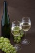 White wine with bottle, glasses and grapes